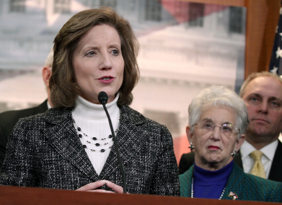 FILE - March 25, 2014, then, U.S. Rep. Vicky Hartzler, R-Mo., left, speaks to reporters on Capitol Hill in Washington on March 25, 2014. Senate candidate Vicky Hartzler's campaign says she has no plans to delete a tweet in which she wrote, "Women's sports are for women, not men pretending to be women," even after Twitter said she won't be able to tweet, retweet, follow or like posts until she does. Twitter on Monday, Feb.