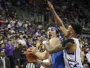 UCLA guard Jaime Jaquez Jr., left, is guarded by Washington guard Jamal Bey, right, during the first half of an NCAA college basketball game, Monday, Feb. 28, 2022, in Seattle. (AP Photo/Ted S.