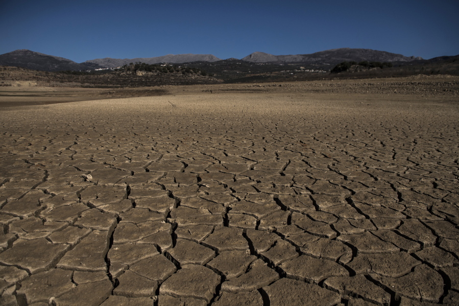 Part of the Vinuela reservoir is seen dry and cracked due to lack of rain in La Vinuela, southern Spain, Feb. 22, 2022. Declining agricultural yields in Europe, and the battle for diminishing water resources, especially in the southern part of the continent, are key risks as global temperatures continue to rise. These conclusions are part of a new United Nations report that will help countries decide how to prevent the planet from warming further.