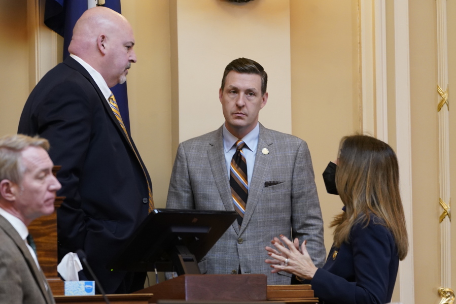 Virginia House Speaker, Del. Todd Gilbert, R-Shenandoah, left, speaks with former Speaker Eileen Filler-Corn, right, D-Fairfax, and Del. Israel O'Quinn, R-Bristol, center, during the House session at the Capitol Tuesday Feb. 1, 2022, in Richmond, Va.