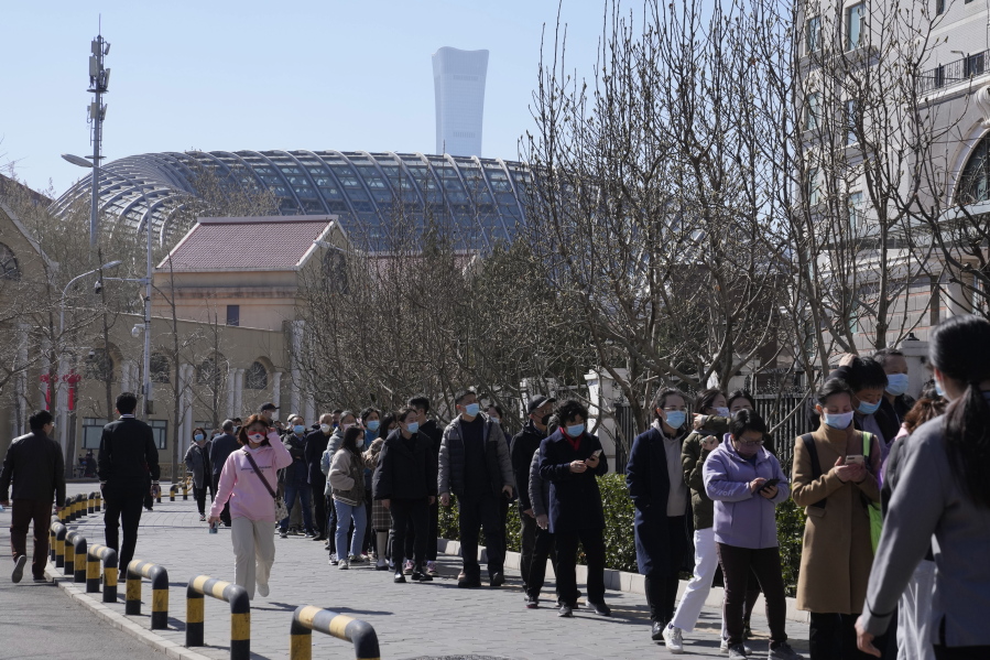 Residents line up for COVID test on Monday, March 14, 2022, in Beijing. Chinese authorities reported more than 1,300 locally transmitted cases of COVID-19 across dozens of mainland cities Monday as the fast-spreading variant commonly known as "stealth omicron" fuels China's biggest outbreak in two years.