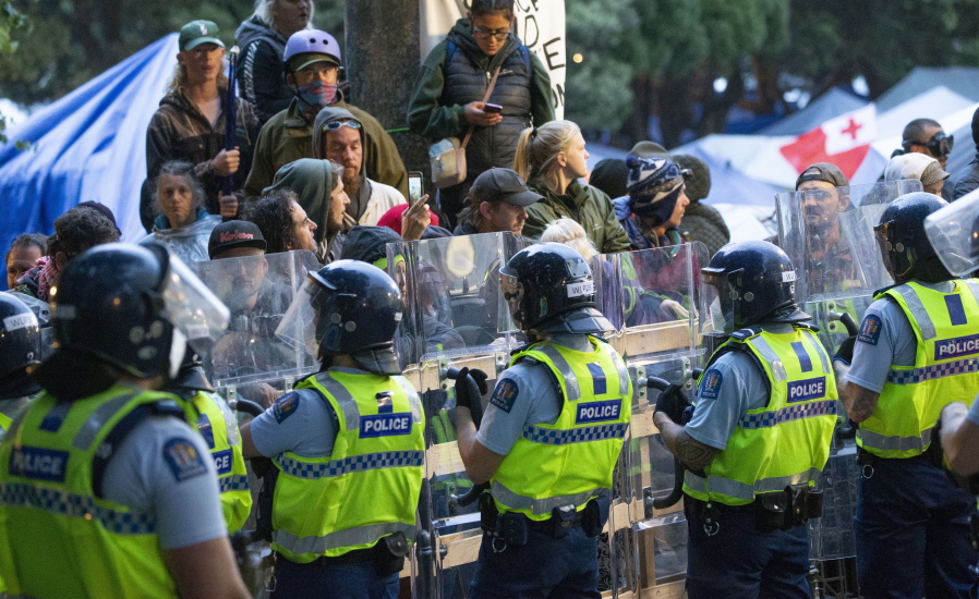Demonstrators and police face off at a protest opposing vaccine mandates today in Wellington, New Zealand.