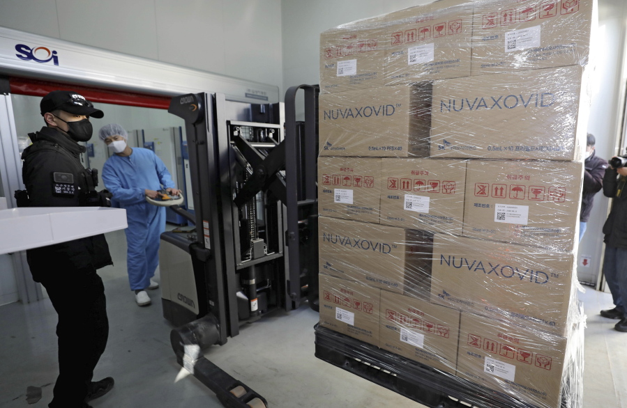 FILE - A worker moves boxes carrying Novavax's COVID-19 vaccine at SK Bioscience Co. in Andong, South Korea, on Feb. 9, 2022. Before the pandemic, Novavax was a small American company that had never brought any vaccine to market. Its shots have proven highly effective, but it is relying heavily on other companies to make them.