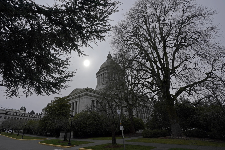 The sun appears through cloudy skies Thursday, March 10, 2022, above the Legislative Building at the Capitol in Olympia, Wash. Washington lawmakers were wrapping up their work Thursday with final votes on a supplemental state budget and a transportation revenue package before planning to adjourn the legislative session. (AP Photo/Ted S.