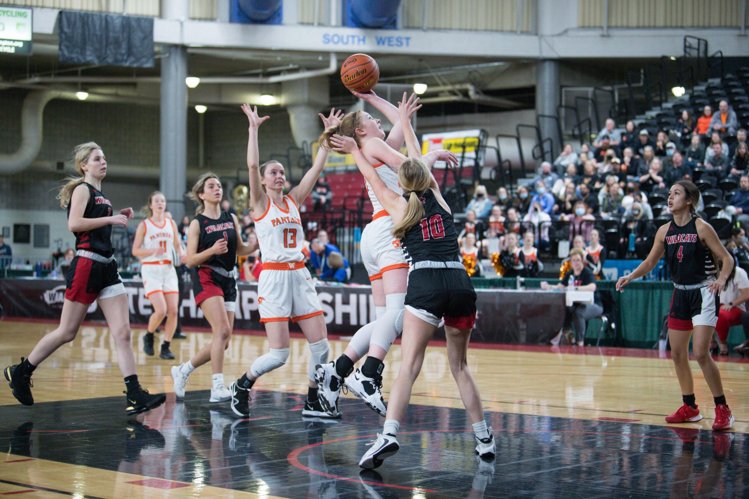 Washougal's Savea Mansfield, center, flips in a shot in a Class 2A girls state fourth-place semifinal game against Archbishop Murphy on Friday at the Yakima Valley SunDome.
