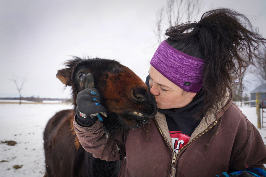 Kym Garvey gives Lemon the donkey a kiss on the snout. Lemon was born with wry nose, which makes her look different from other donkeys, causing them to shun her. More than 43 equine were under the care of Kym Garvey at Save The Brays Donkey Rescue Friday, March 10, 2022, in Milaca, Minnestota. (Shari L. Gross/Minneapolis Star Tribune/TNS) (Shari L.
