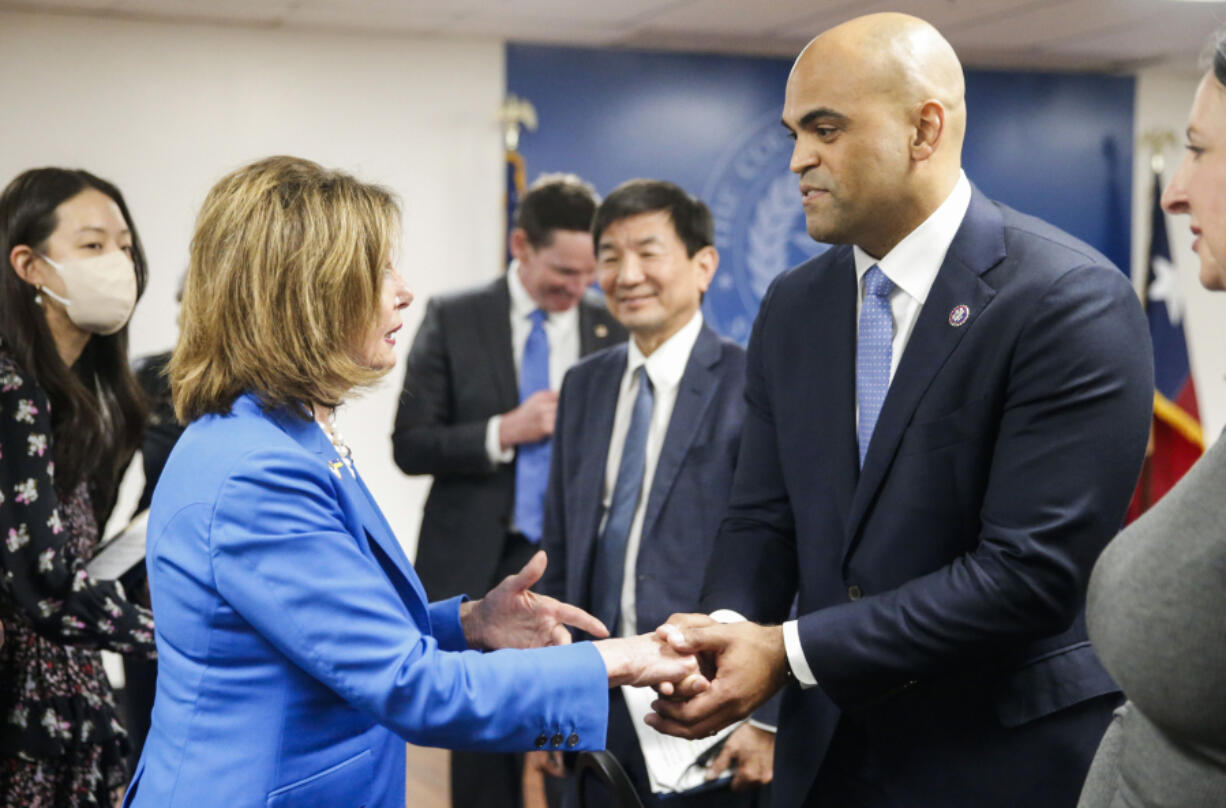 House Speaker Nancy Pelosi shakes hand with Rep. Colin Allred, D-Texas, right, after a roundtable discussion March 21, 2022, at Dallas County Health and Human Services in Dallas.