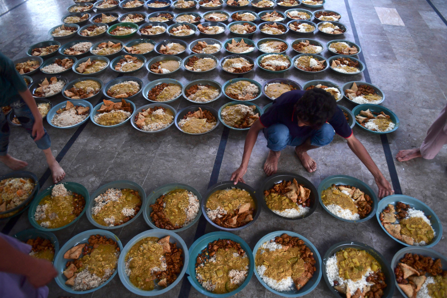 Volunteers prepare iftar food plates April 4 for Muslim devotees before breaking their fast on the holy fasting month of Ramadan in Karachi, Pakistan.