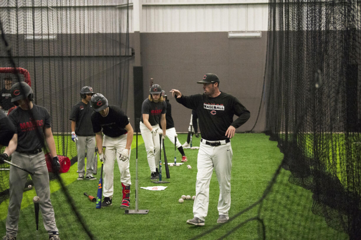 Camas baseball coach Stephen Short instructs his players during a practice Tuesday at Camas High School's Fieldhouse, an indoor practice facility.