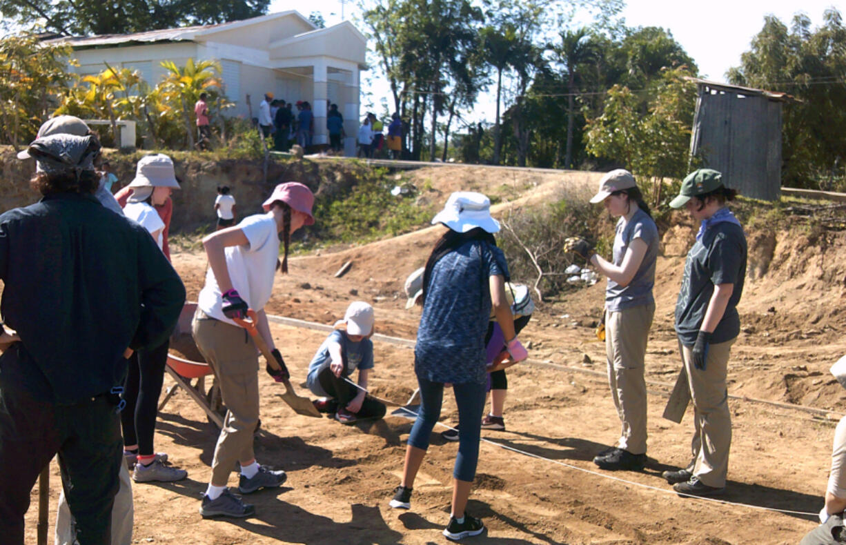 Volunteers from Vancouver-based nonprofit Courts For Kids work to level the ground while building a sports court in El Rodeo, Dominican Republic, on April 3.