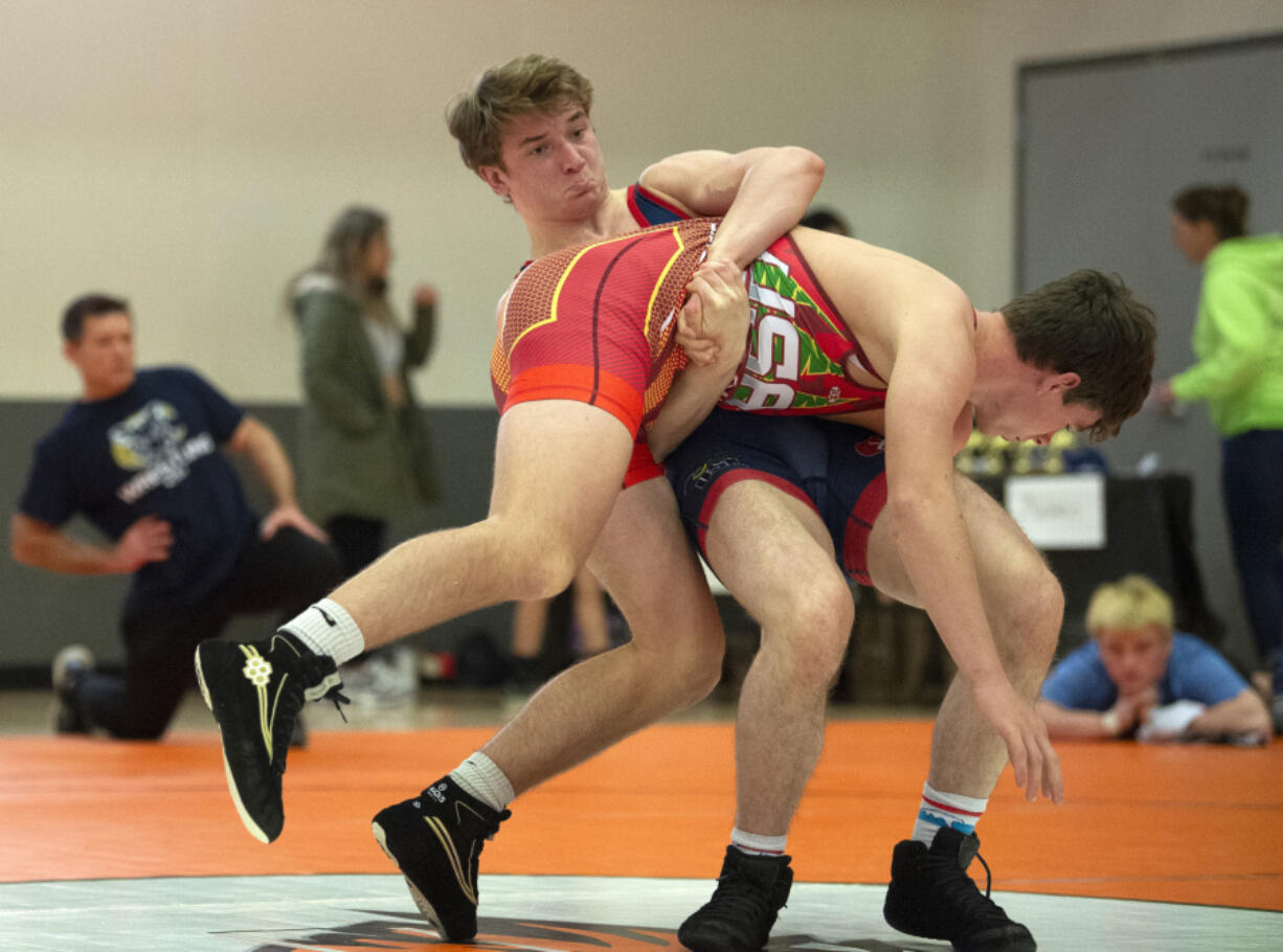 Battle Ground's Gunnar Henderson grabs hold of Ethan Ensrud of Canby Mat Club in a 160-pound Greco match during the Southwest Washington Championships on Saturday at Battle Ground High School.