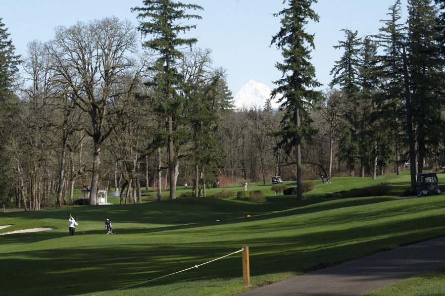 Union golfer Jade Gruher hits a shot onto the ninth green at Camas Meadows, which is one of three golf courses in Clark County hosting multiple high school golf programs this spring.