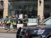 Vancouver firefighters meet after extinguishing a fire Thursday afternoon at Diosa, a new downtown Vancouver Mexican restaurant that was scheduled to open Tuesday. Owner Jorge Castro said a decoration caught fire while they were doing a photo shoot and training in the restaurant.