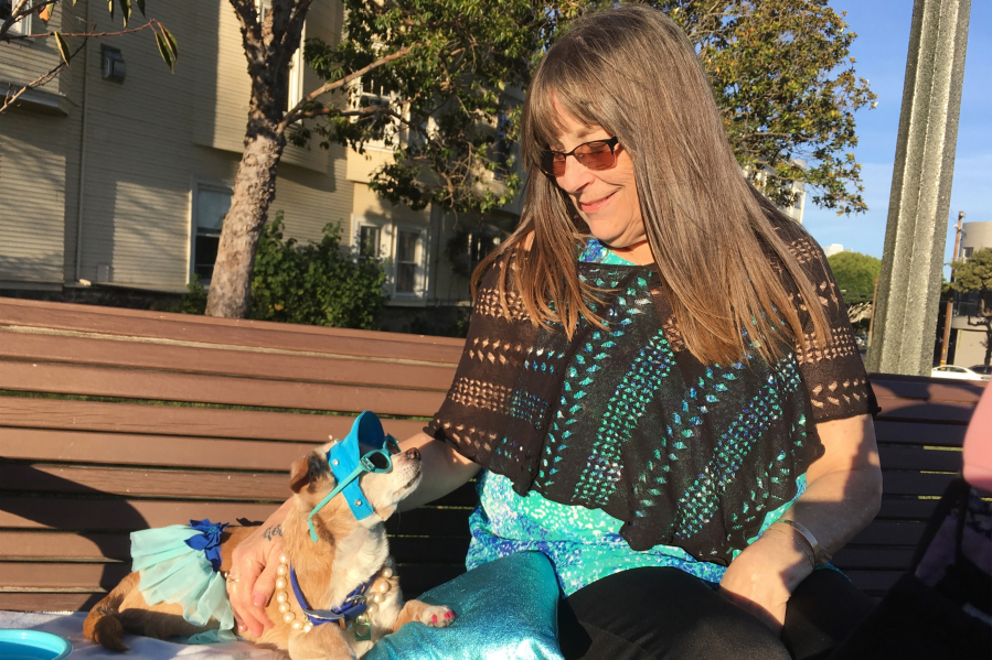 Diana McAllister lounges with her dog, Honey, at a park in San Francisco. Some pet owners in the area report waiting months for veterinarian appointments.