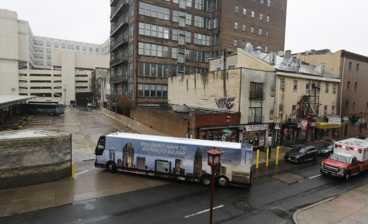 A Greyhound bus turns into the Greyhound Bus Station on 10th Street in Philadelphia's Chinatown on Thursday, April 7, 2022. Greyhound abruptly changed the configuration of its cramped station in Chinatown and busses now enter from the terminal's former exit on 10th Street.