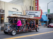 The Couve Cycle party cycle en route to its next small-business shopping destination during the Sip, Shop and Spin tour in downtown Vancouver on Nov. 30, 2019.