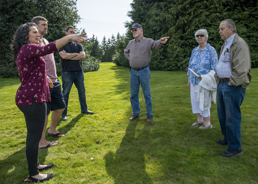 Local residents gather outside the home of Dean Hergesheimer, center, to discuss the possibility of a road connecting Northeast 174th and Northeast 179th streets.