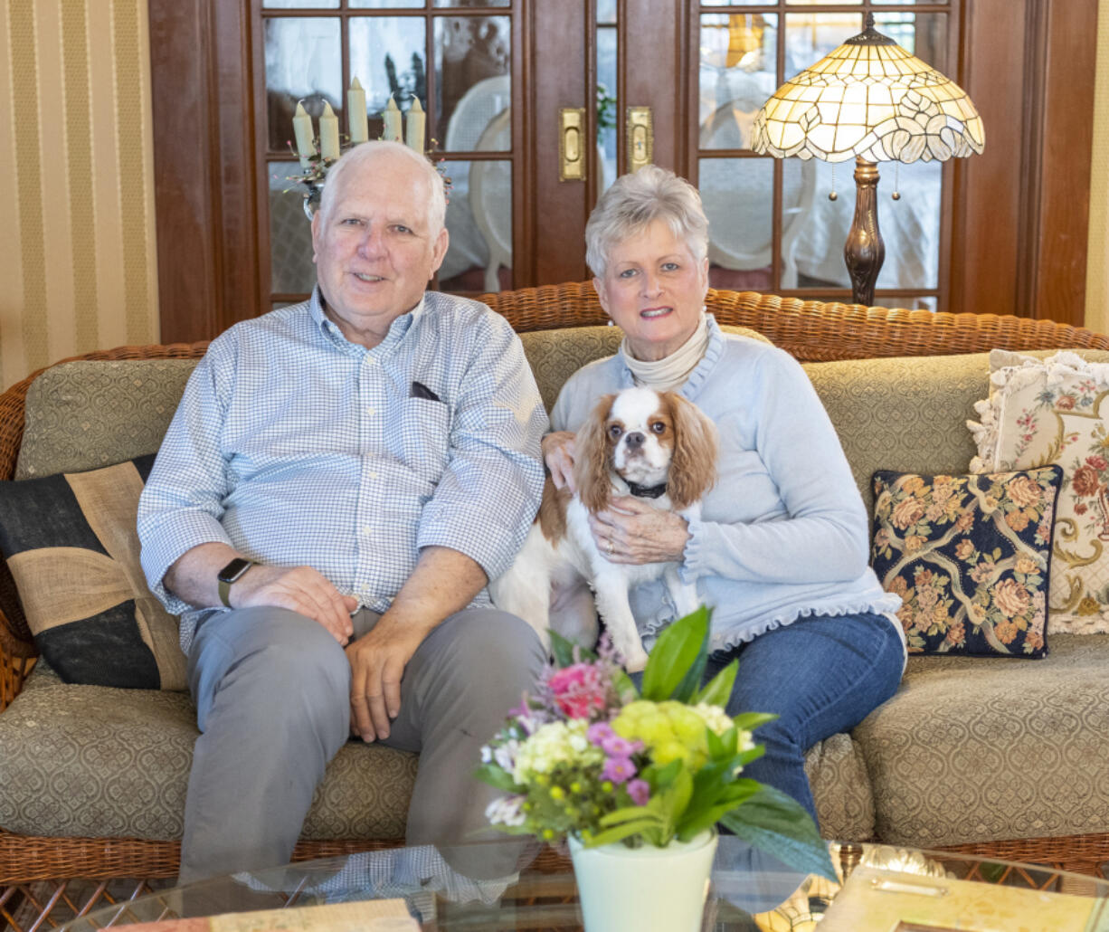 Briar Rose Inn owners Ted, left, and Sallie Reavey sit in their living room with Gracie, their 1-year-old Cavalier King Charles Spaniel, the furry mascot of this downtown Vancouver bed-and-breakfast.