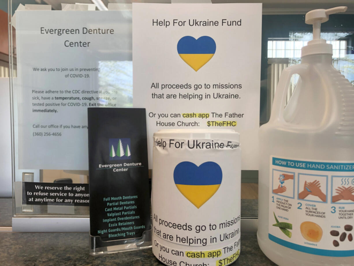 A donation bin at Evergreen Denture Center's front desk. All proceeds go toward Father's House Church, which is providing financial support for Ukrainian churches offering aid on the front lines.