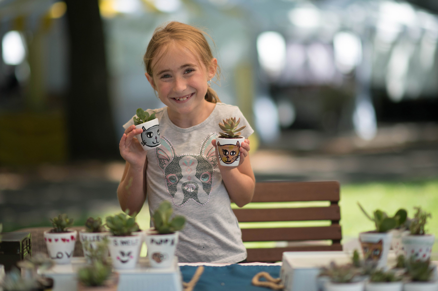 Emily Corsen, now 12 years old, shows off her succulents for sale during the Vancouver Farmers Market's kid market in 2019. The market has now partnered with the Greater Vancouver Chamber to provide free booths for young entrepreneurs and training to create and implement a business plan.