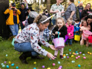Emily Edwards of Vancouver helps her daughter Evette Edwards, 2, collect goodies during Saturday afternoon's annual Easter egg hunt at Vancouver Elks Lodge No. 823. Evette's age group, while competitive, was a tad less high-energy than the older groups. An estimated 200-plus children took part in the event, pursuing 2,400 eggs.