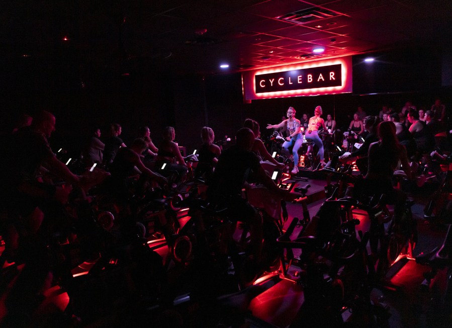 Jessica Mossman leads a classic cycling class Tuesday at CycleBar in Vancouver. Since the state mask mandate lifted in March, local gyms have begun seeing a boost in new and returning clients. "Some people coming into the studio are coming to look for a community," said CycleBar general manager Aly Hendershot.