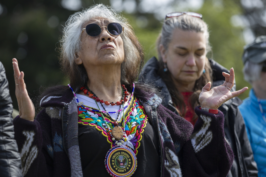 Estelita Little Star Robinson, a U.S. Army veteran, looks to the sky while the drum and singing circle performs during the Chief Redheart ceremony Saturday at the Fort Vancouver National Historic Site. The memorial event pays tribute to the Nez Perce tribal leader and his band of 33 members who were captured from their homeland in Idaho and imprisoned at Fort Vancouver in 1877.