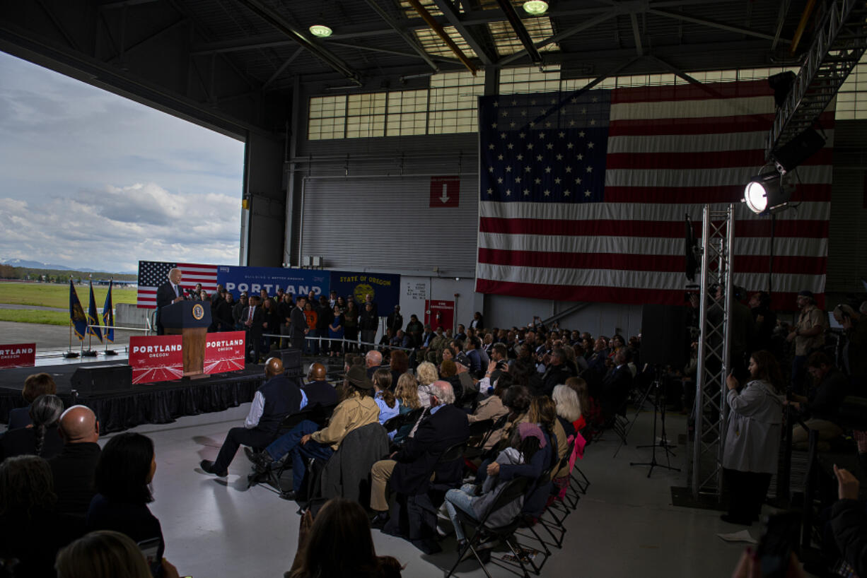 President Joe Biden looks to a crowd at a Portland Air National Guard hangar while speaking about his administration's $1.2 trillion infrastructure legislation signed in November. He noted how the federal funding would be invested in Oregon's airport, roads and bridges.