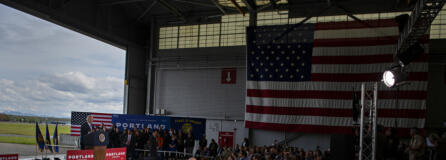 President Joe Biden looks to a crowd at a Portland Air National Guard hangar while speaking about his administration's $1.2 trillion infrastructure legislation signed in November. He noted how the federal funding would be invested in Oregon's airport, roads and bridges.