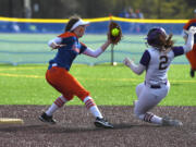 Ridgefield sophomore Mallory Vancleave, left, makes a play at second base Friday, April 22, 2022, during the Spudders' 2-1 win against Columbia River at the Ridgefield Outdoor Recreation Complex.
