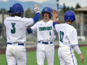 Mountain View's Michael Gordon, center, celebrates with teammates Wednesday, April 27, 2022, during the Thunder's 7-1 win against Heritage at Union High School.