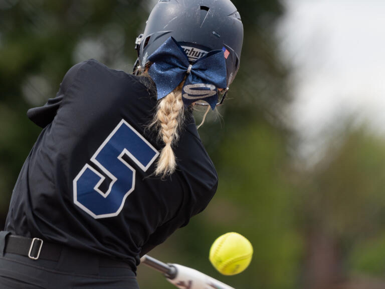 Skyview's Skylar Groesbeck, wearing a Storm bow in her hair, swings at a pitch in a 4A Greater St. Helens League softball game on Friday, April 29, 2022, at Battle Ground High School. Skyview beat Battle Ground 2-0.