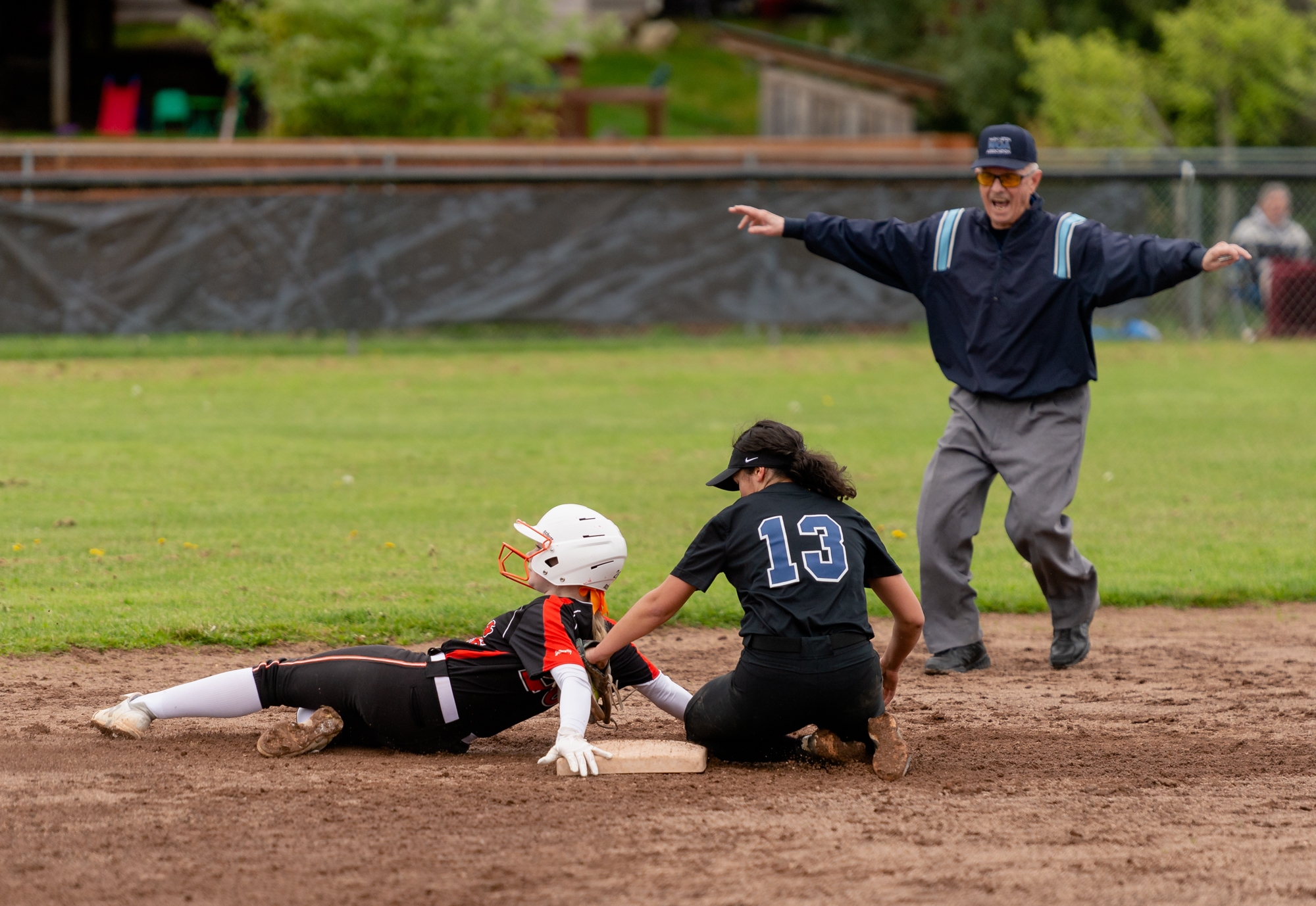 An umpire calls Battle Ground's Hailey Ferguson safe on a stolen base, as she beat the tag of Skyview's Kya Jenkins in a 4A Greater St. Helens League softball game on Friday, April 29, 2022, at Battle Ground High School. Skyview beat Battle Ground 2-0.