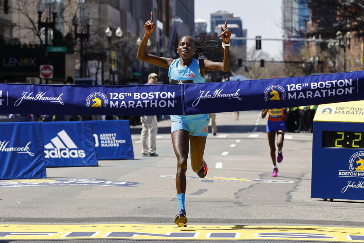 Peres Jepchirchir, of Kenya, crosses the finish line to win the women's division of the 126th Boston Marathon, Monday, April 18, 2022, in Boston.