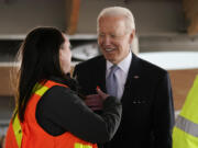 President Joe Biden listens as he tours a construction area at Portland International Airport, Thursday, April 21, 2022, in Portland, Ore.