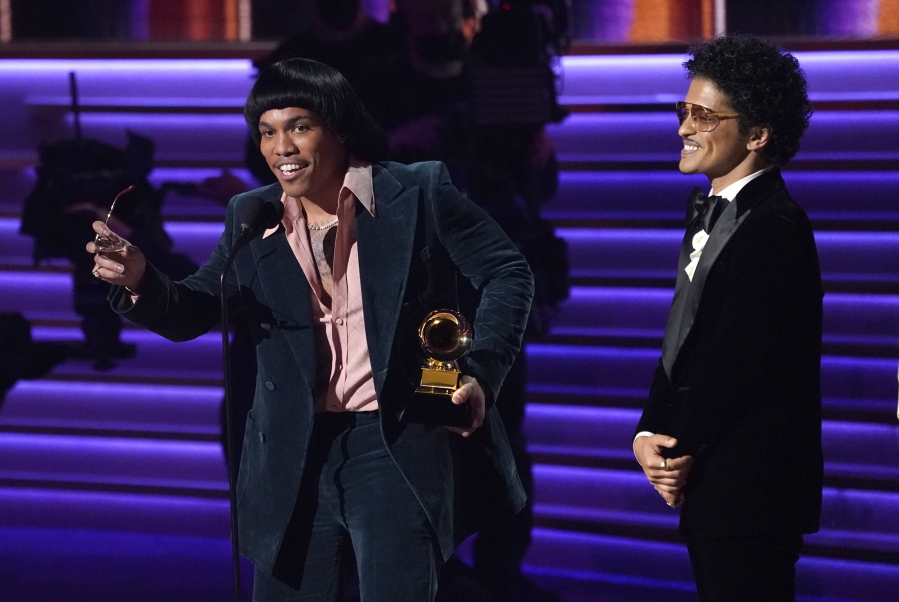 Anderson .Paak, left, and Bruno Mars of Silk Sonic accept the award for record of the year for "Leave the Door Open" at the 64th Annual Grammy Awards on Sunday in Las Vegas.