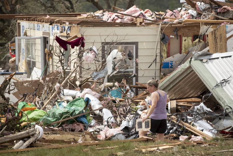 Michelle Light salvages belongings from her home on FM 2843 and Cedar Valley Road near Salado, Texas, on Wednesday, April 13, 2022, a day after a tornado destroyed the house.