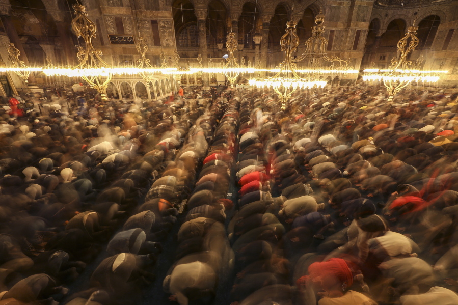 Muslim worshippers perform a night prayer called 'tarawih' during the eve of the first day of the Muslim holy fasting month of Ramadan in Turkey at Hagia Sophia mosque in Istanbul, Turkey, Friday, April 1, 2022.
