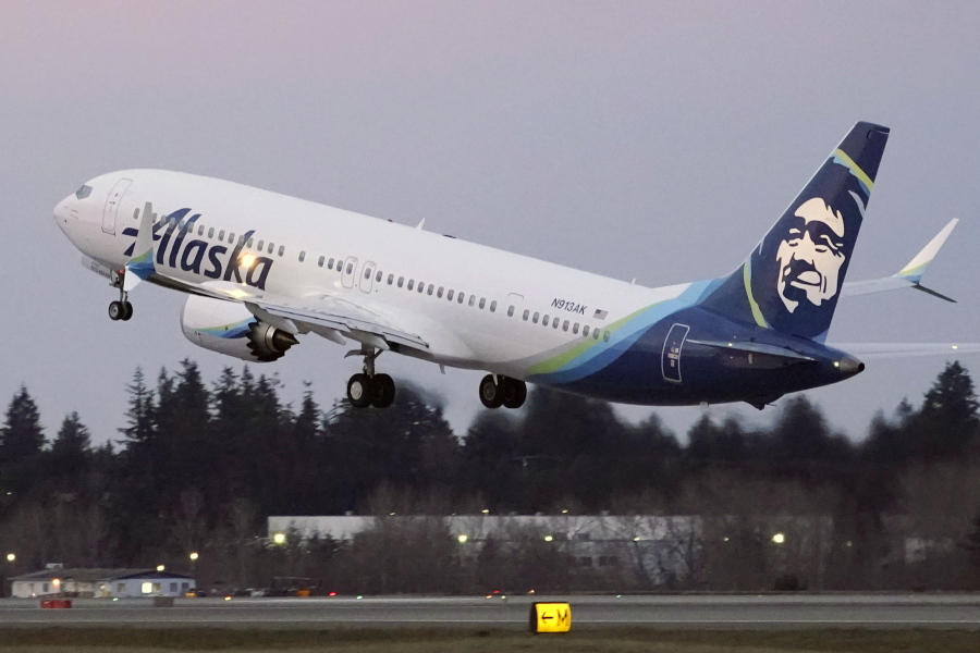 FILE - In this Monday, March 1, 2021 file photo, The first Alaska Airlines passenger flight on a Boeing 737-9 Max airplane takes off on a flight to San Diego from Seattle-Tacoma International Airport in Seattle. Dozens of flights along the U.S. West Coast were canceled Friday, April 1, 2022 as Alaska Airlines pilots picketed during ongoing contract negotiations with the airline. (AP Photo/Ted S.
