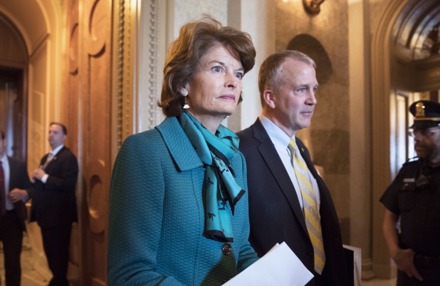 FILE - Sen. Lisa Murkowski, R-Alaska, and Sen. Dan Sullivan, R-Alaska, leave the chamber after a vote on Capitol Hill in Washington on May 10, 2017. A rural Alaska man who threatened to kill both of Alaska's U.S. senators in a series of profanity-laden messages left at their congressional offices will be sentenced Friday, April 8, 2022. Jay Allen Johnson, who said he was too old and ill to carry out his threats, partially blamed his behavior on the mixture of pain medications and alcohol and the isolation that was prevalent during the five-month span of 2021 when he left the threatening voicemails. (AP Photo/J.