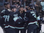 Seattle Kraken defenseman Jamie Oleksiak, forward Kole Lind, forward Victor Rask and defenseman Will Borgen, from left, celebrate a goal during the first period of the team's NHL hockey game against the Colorado Avalanche, Wednesday, April 20, 2022, in Seattle.