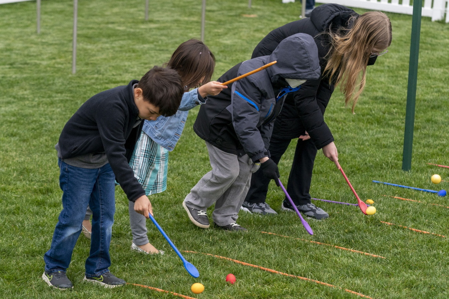 Kids roll eggs on the South Lawn of the White House in Washington, Monday, April 18, 2022, during the White House Easter Egg Roll.