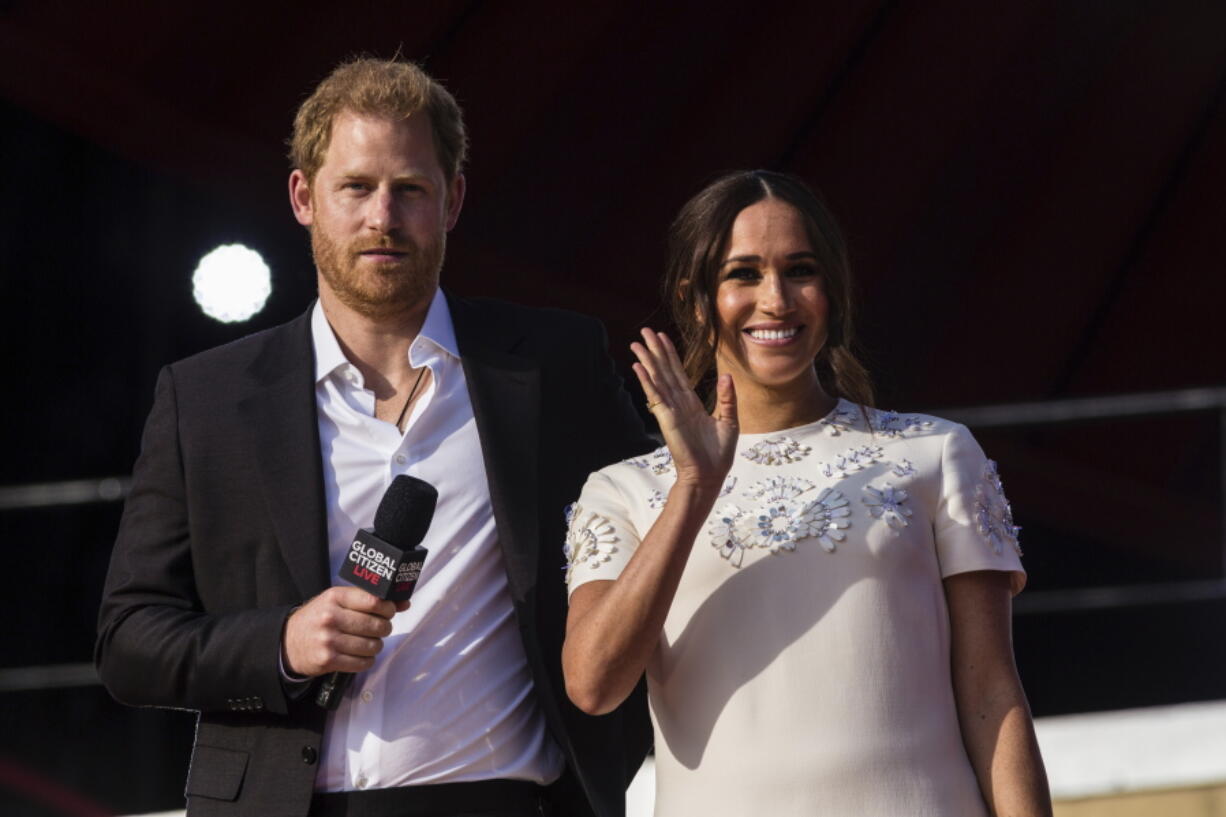FILE - Prince Harry and his wife Meghan speak during the Global Citizen festival, on Sept. 25, 2021 in New York. Prince Harry and his wife Meghan have visited Queen Elizabeth II at Windsor Castle on their first joint visit to the U.K. since they gave up formal royal roles and moved to the U.S. more than two years ago.