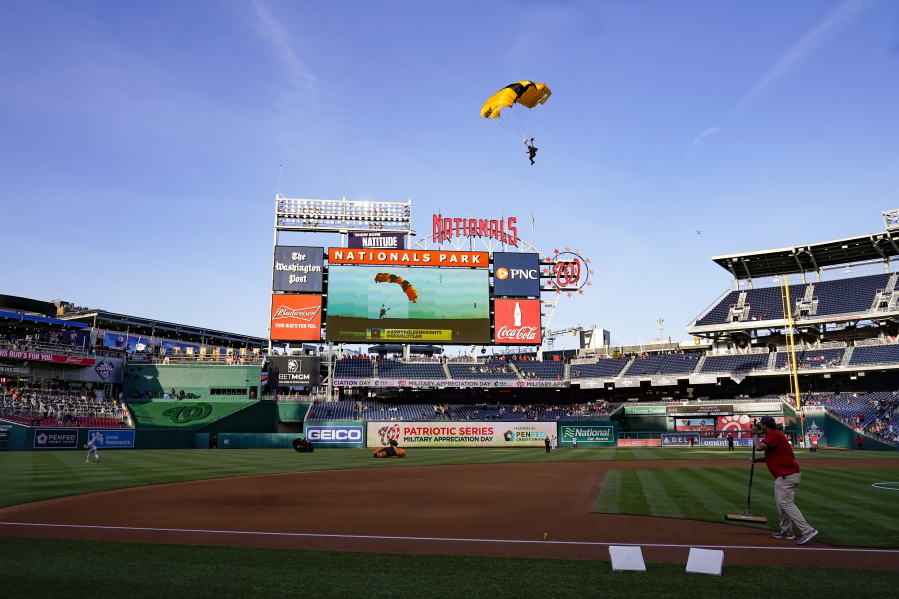 The U.S. Army Parachute Team the Golden Knights descend into National Park before a baseball game between the Washington Nationals and the Arizona Diamondbacks Wednesday, April 20, 2022, in Washington. The U.S. Capitol was briefly evacuated after police said they were tracking an aircraft "that poses a probable threat," but the plane turned out to be the military aircraft with people parachuting out of it for a demonstration at the Nationals game, officials told The Associated Press.