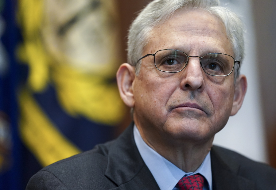 FILE - Attorney General Merrick Garland listens during a meeting of the COVID-19 Fraud Enforcement Task Force at the Justice Department, March 10, 2022 in Washington. The lawmakers investigating the Jan. 6 attack on the Capitol have been increasingly using their public statements, court filings and committee reports to deliver a blunt message to Garland and the Department of Justice to act on their findings.