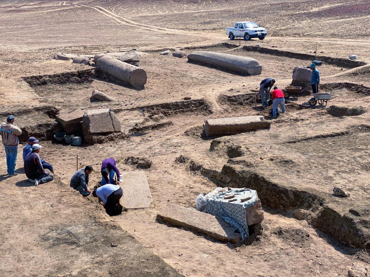 This undated photo provided by the Egyptian Tourism and Antiquities Ministry on Monday shows archeologists working in the ruins of a temple for Zeus-Kasios, the ancient Greek god, at the Tell el-Farma archaeological site in the northwestern corner of the Sinai Peninsula.