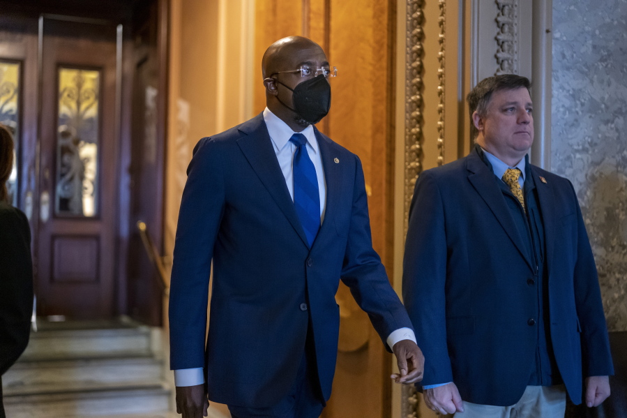 FILE-- Sen. Raphael Warnock, D-Ga., leaves the Senate chamber at the Capitol in Washington on April 7, 2022. Warnock's reelection campaign announced on Thursday, April 14, 2022 that it raised $13.6 million in the first three months of 2022, what the campaign says is the most money ever raised by a U.S. Senate candidate in the first quarter of an election year. (AP Photo/J.