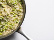 This image released by Milk Street shows a recipe for Couscous Risotto with Asparagus.