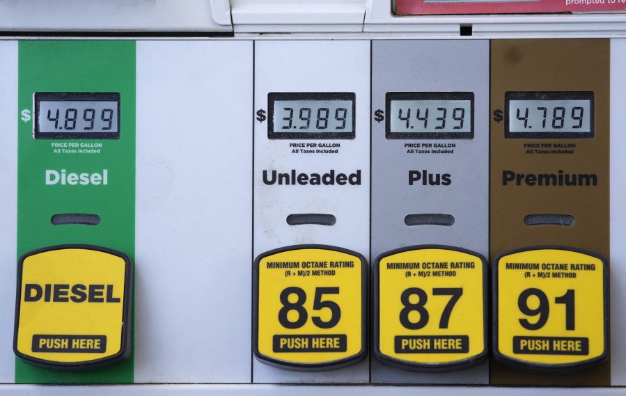 Digital displays are illuminated to mark the prices for the various grades of gasoline available from a pump at a Circle K station Friday, April 22, 2022, in south Denver.