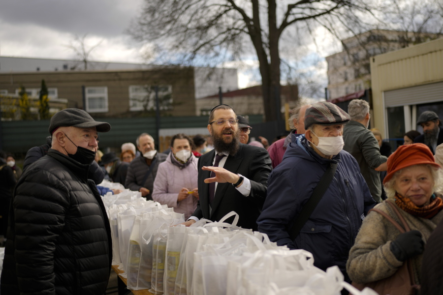 Rabbi Yehuda Teichtal, center, gives instructions April 7 during preparations for the celebration of Jewish Passover at the Chabad Jewish Education Center in Berlin, Germany. Rabbis and Jewish organizations are working around the clock within Ukraine and other parts of Europe to make sure that Jews who remain in Ukraine and refugees who have fled are able to celebrate Passover.
